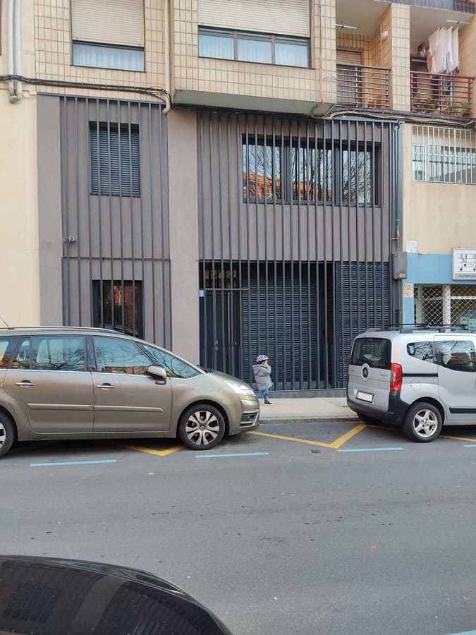 Fachada con lamas metálicas verticales grises en rehabilitación de edificio por Kronos SL, Bizkaia